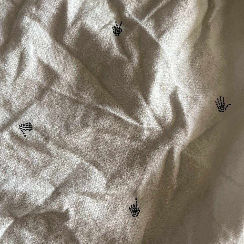 White vans button up shirt, small skeleton hand designs
